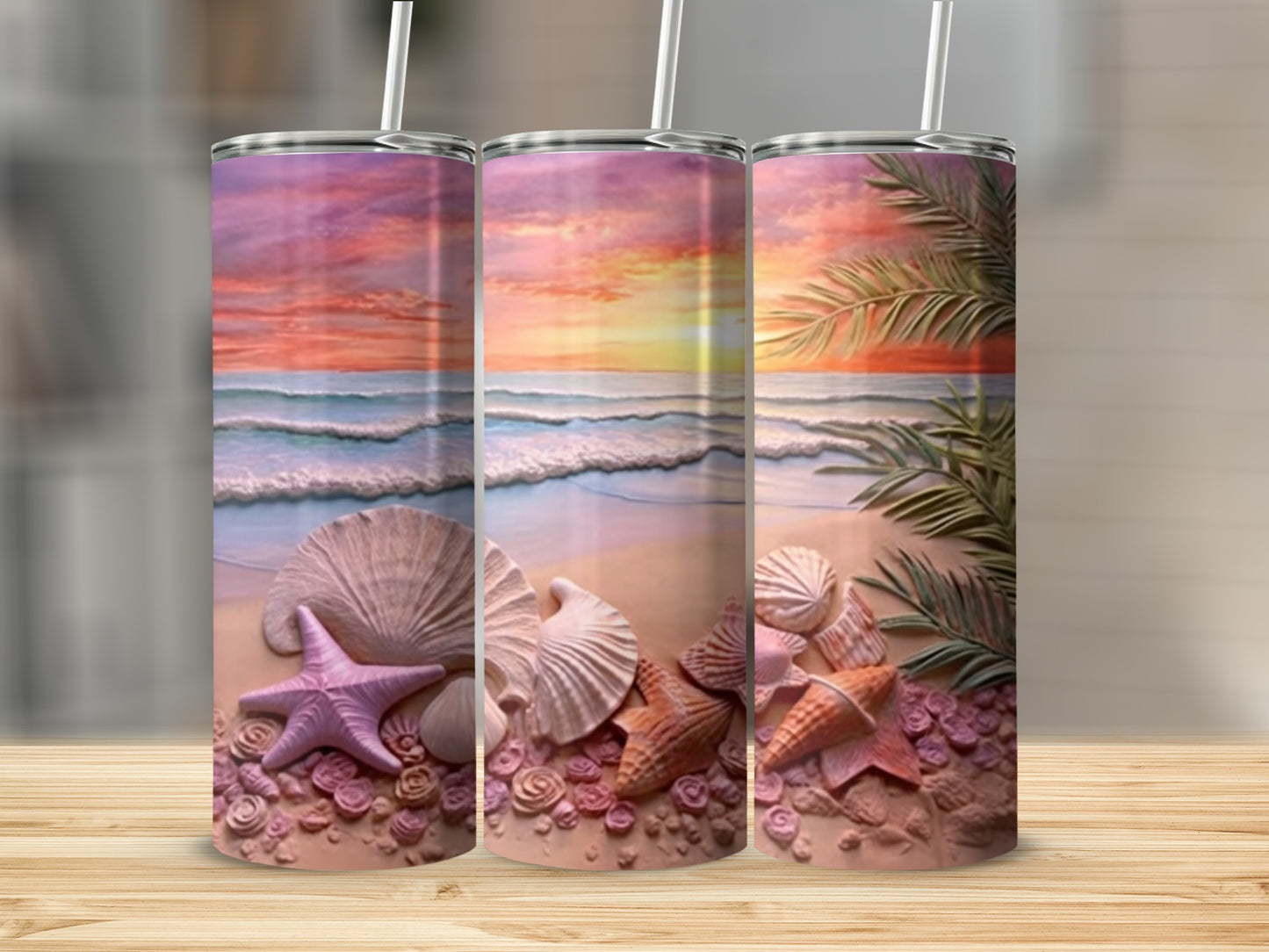 Three tumblers with a beach scene featuring seashells and palm fronds.