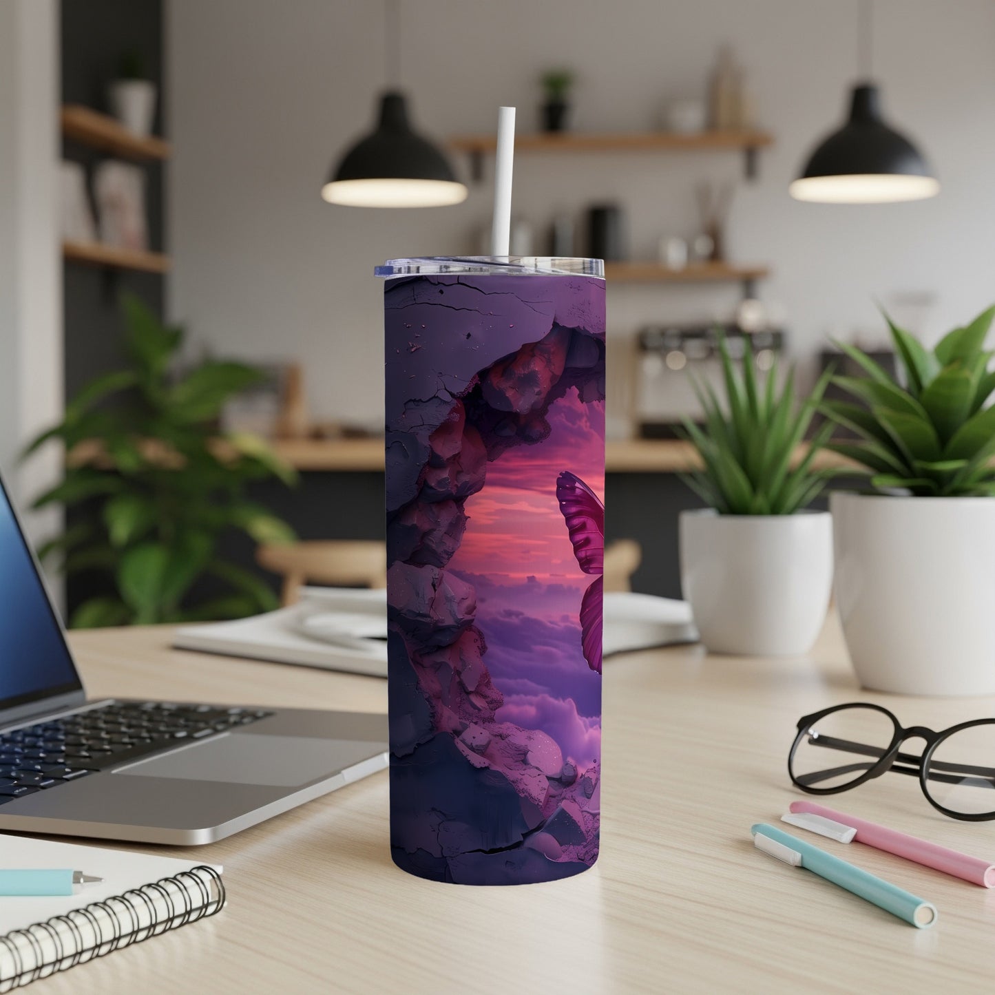 Purple cracked tumbler with butterfly and clouds design, with a straw.