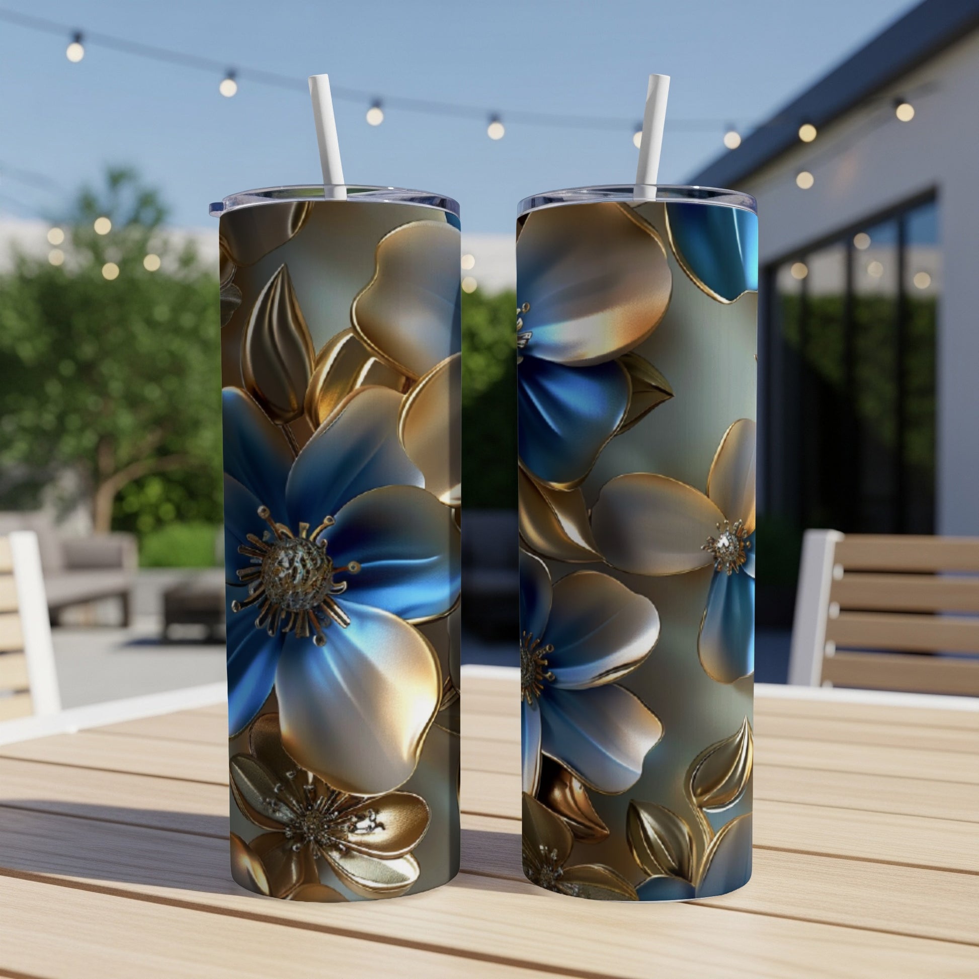 Two tall tumblers with blue and gold floral pattern on outdoor table.