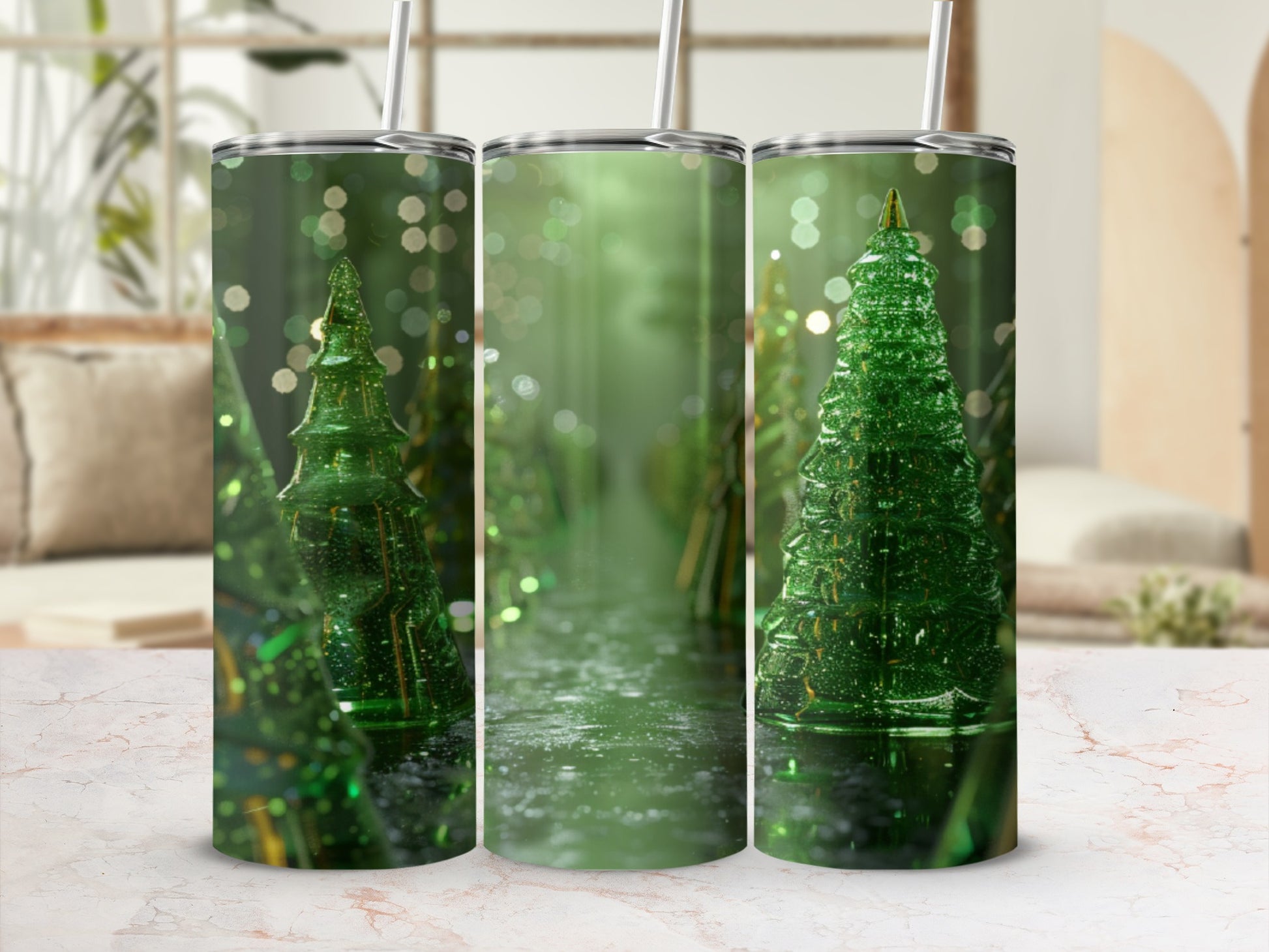 Three sparkly green Christmas trees with straws on a marble surface.