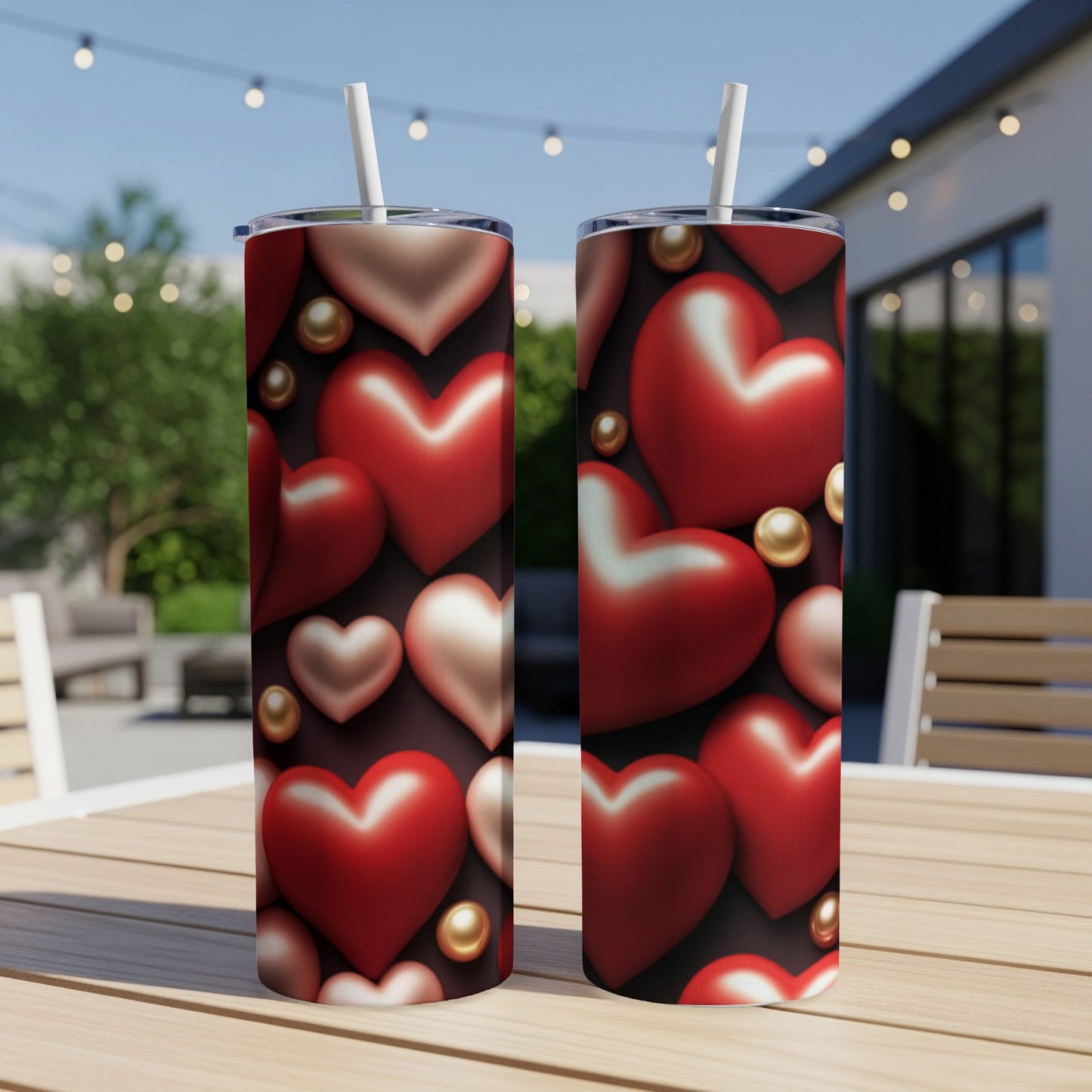 Two insulated tumblers with a red heart and gold bead pattern.