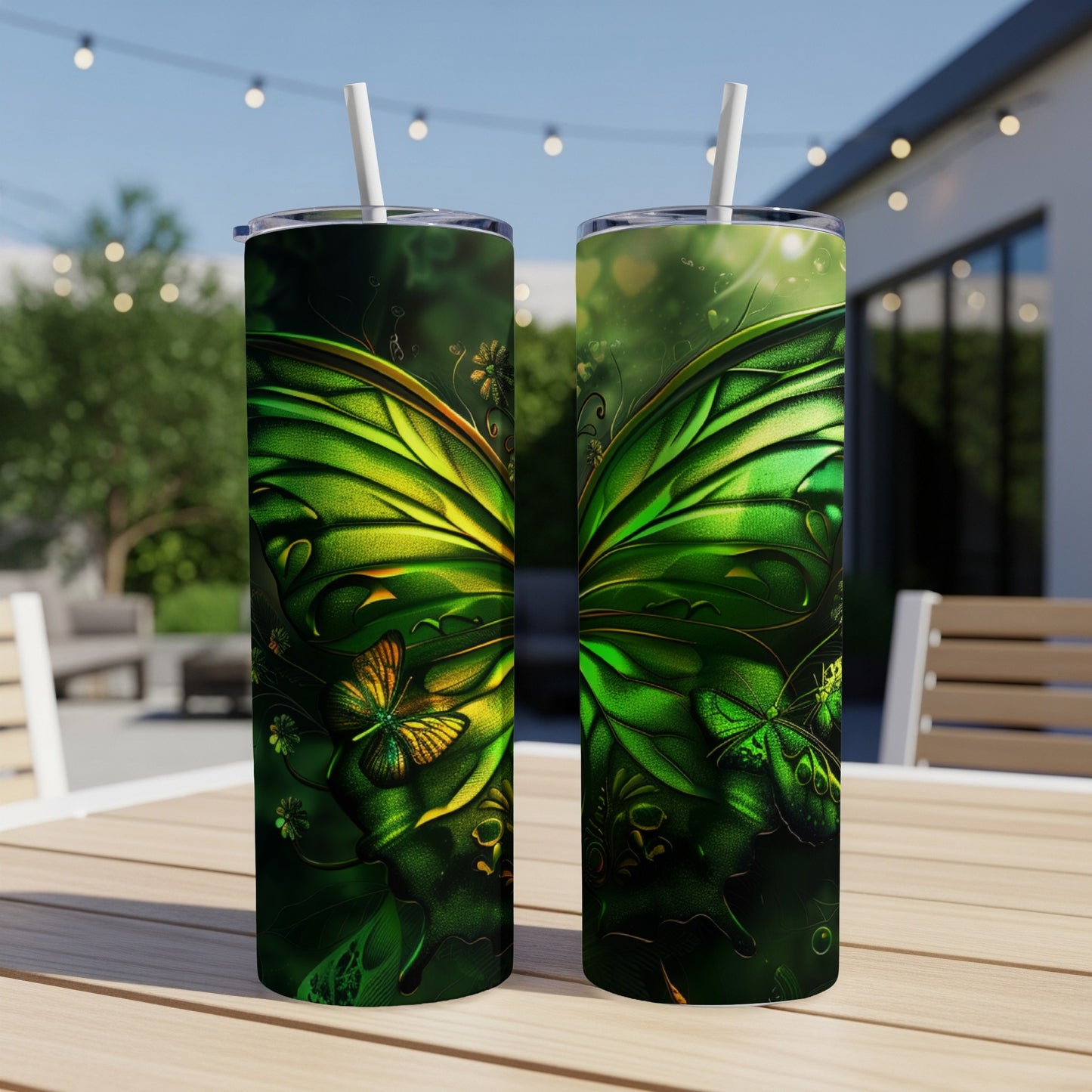 Two green butterfly wing design tumblers on a wooden table outdoors.