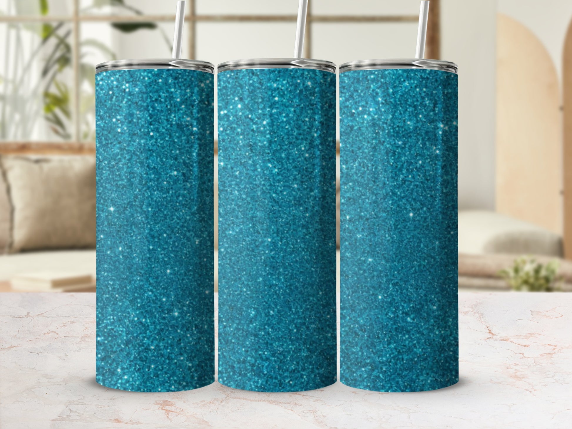 Three turquoise glitter tumblers with straws stand on a marble surface.