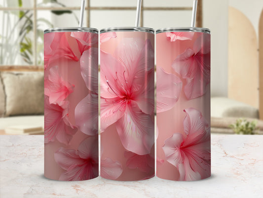 Three tall pink floral tumblers with straws on a marble surface.