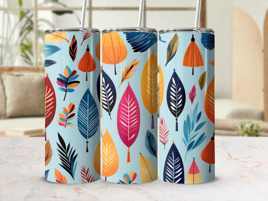 Three patterned tumblers with colorful leaves on a light blue background.