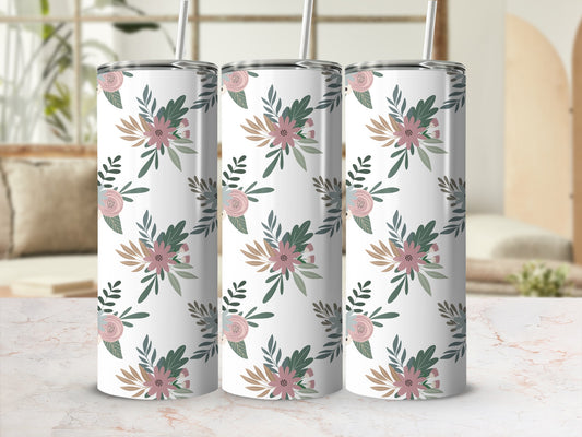 Three tall tumblers with a floral pattern on a table.