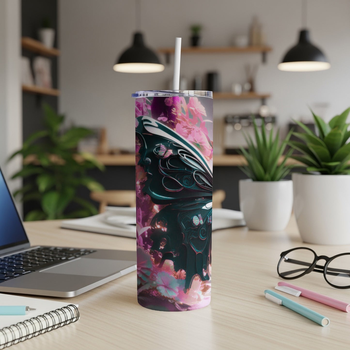 Pink and teal abstract butterfly design on a white tumbler with straw.