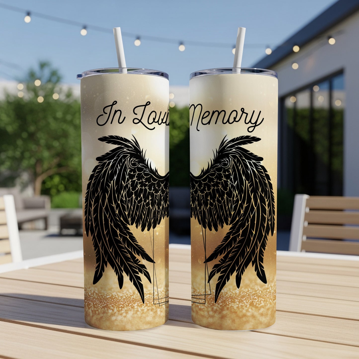 Two tumblers with angel wings and "In Loving Memory" text on a table.