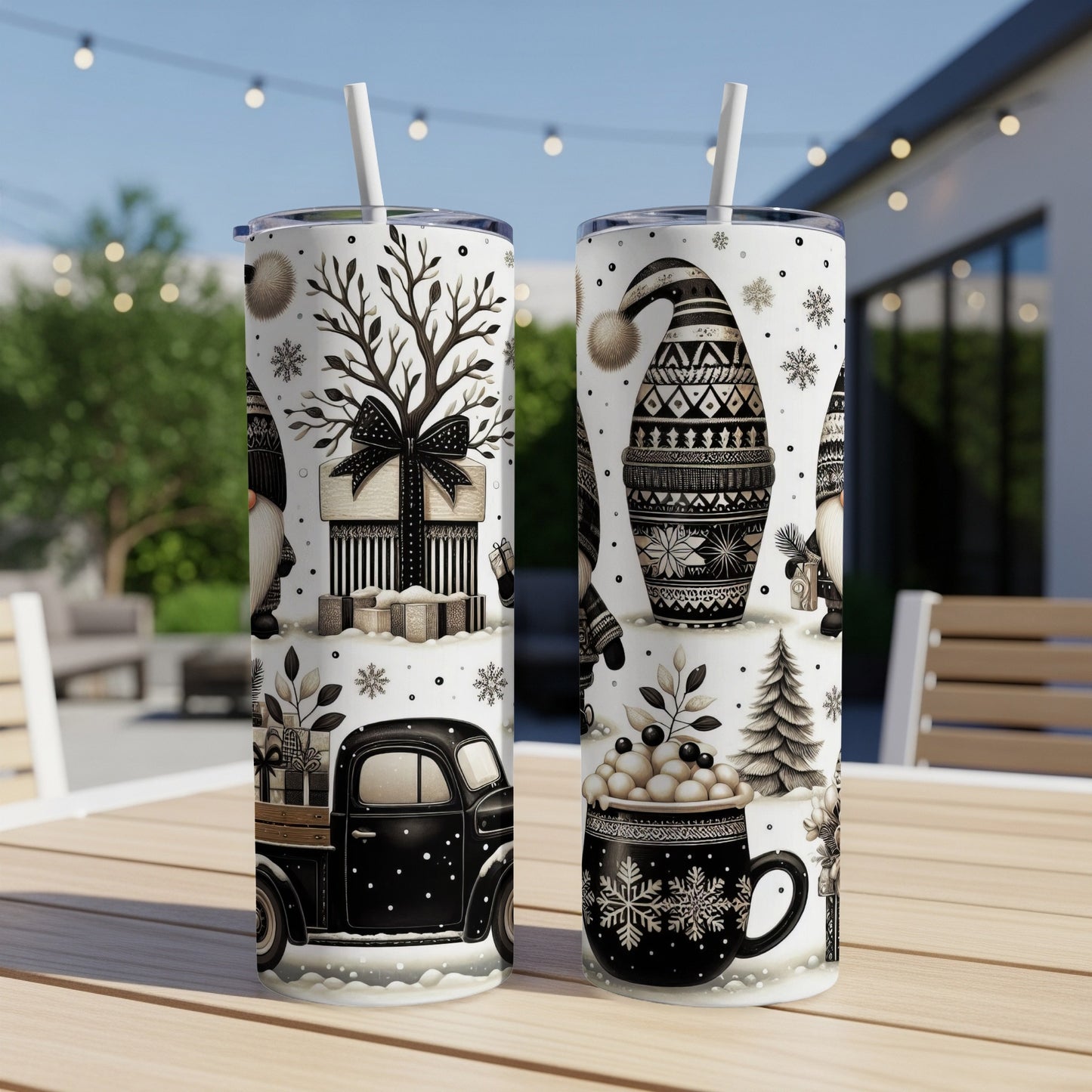 Two tumblers with a black and white gnome and winter holiday pattern.