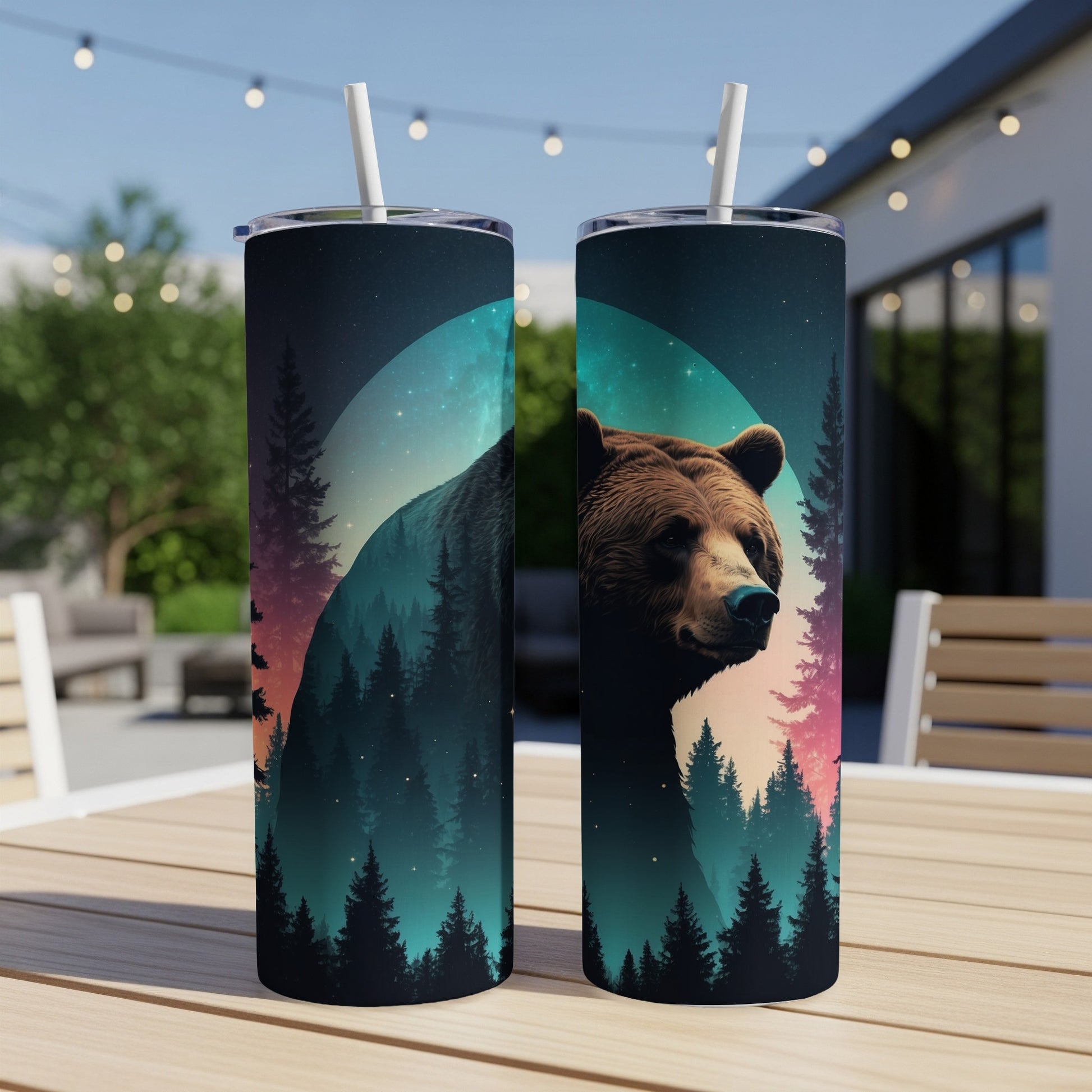 Bear face and forest silhouette on tumblers with straws.