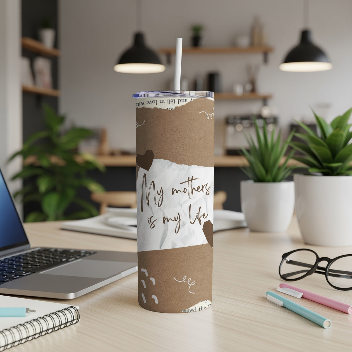 Brown tumbler with torn paper graphic and "My mothers is my life" text.