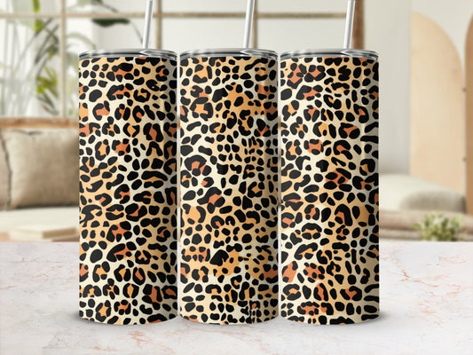 Three tumblers with a leopard print pattern displayed on a marbled surface.