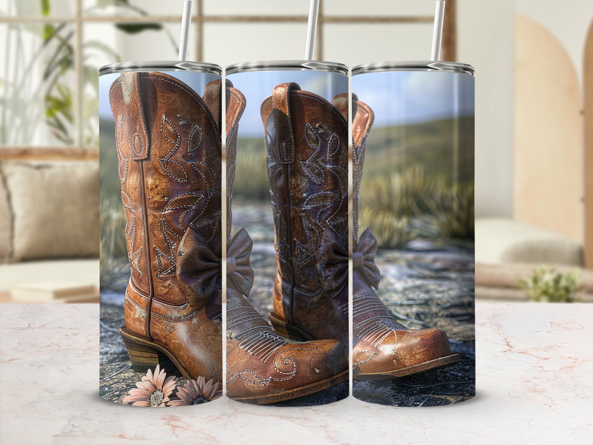 Brown leather cowboy boots with floral accents and straw background.