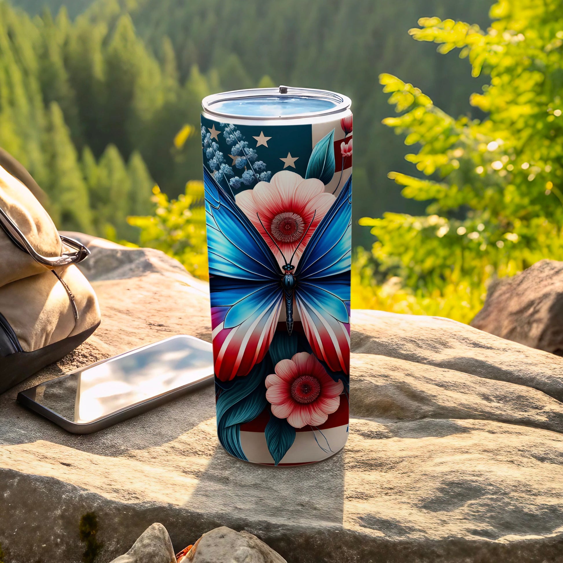 Tumbler with patriotic butterfly and floral design outdoors.