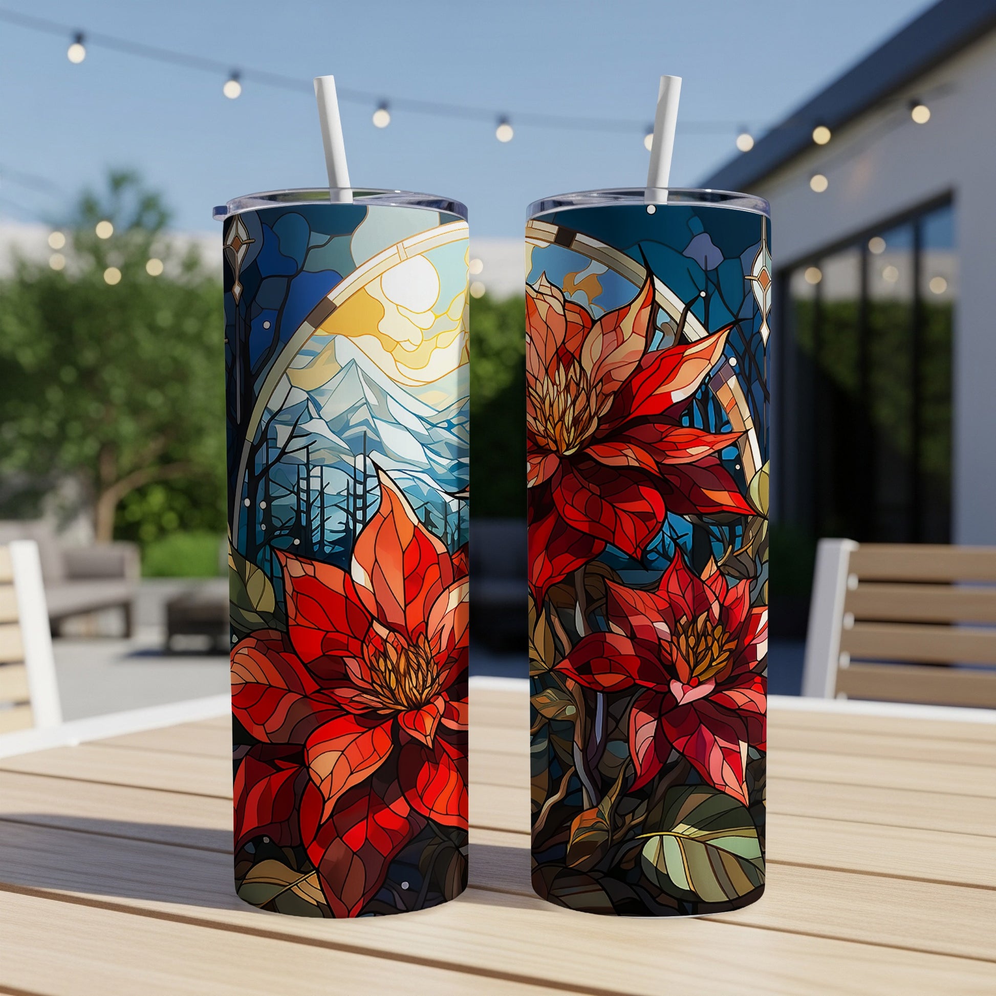 Two tall tumblers with poinsettia and stained-glass mountain design.