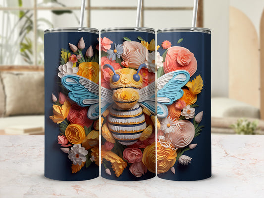 Bee and floral design on navy blue tumbler with straw.