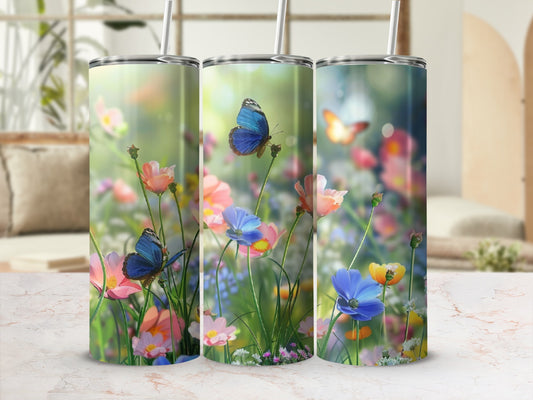 Three tumblers with a floral and butterfly design on a blurred background.