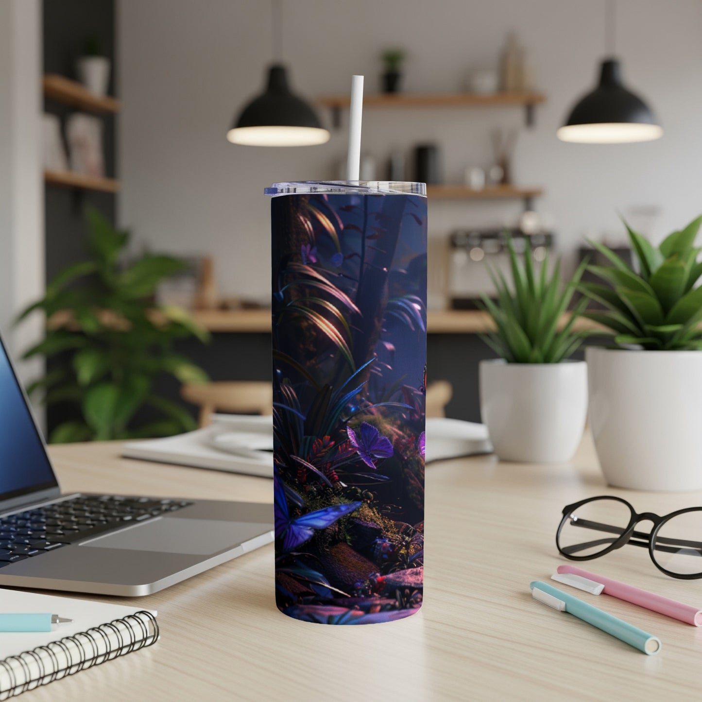 Dark blue tumbler with colorful jungle foliage and a butterfly.