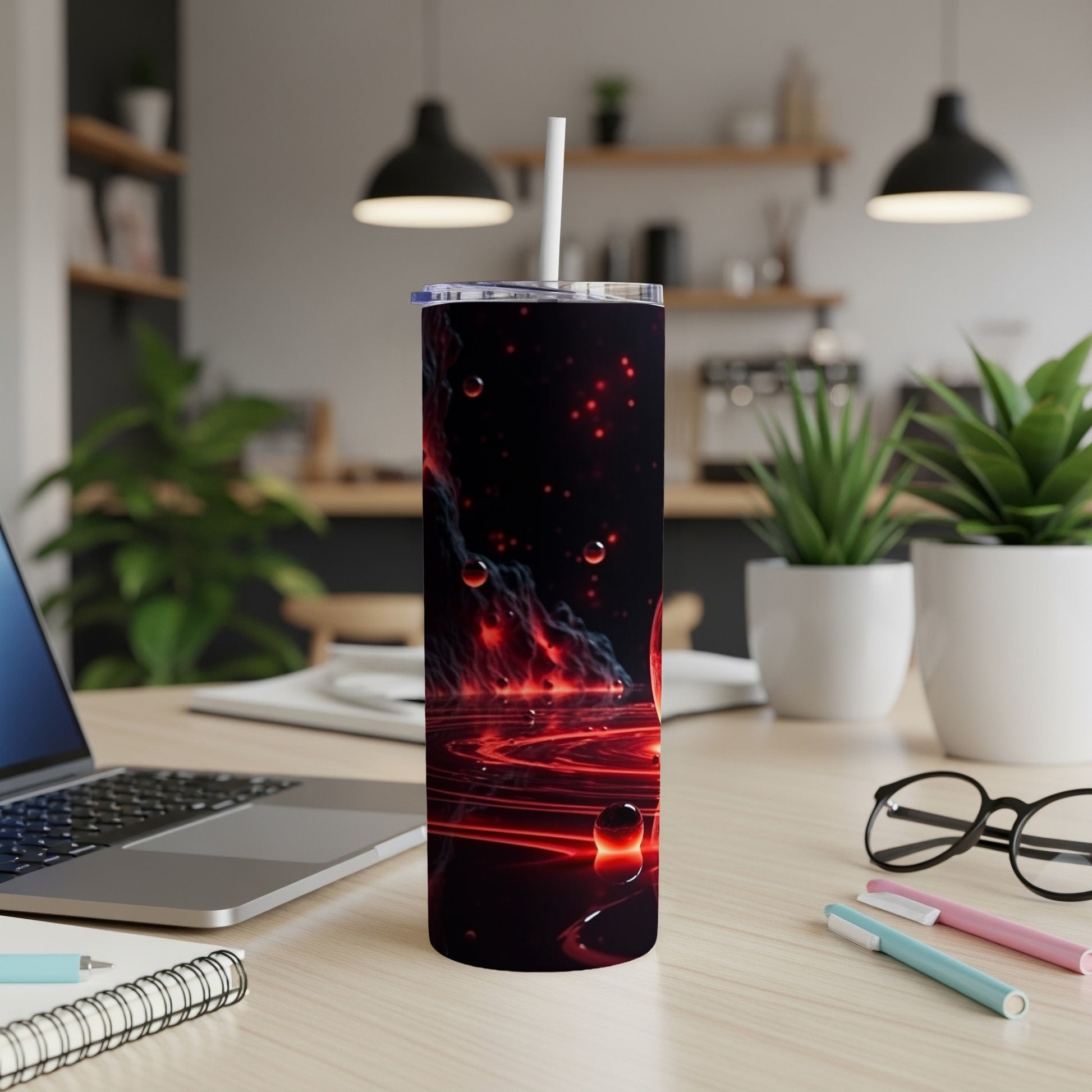 Red and black swirling cosmic pattern on a tumbler with straw.