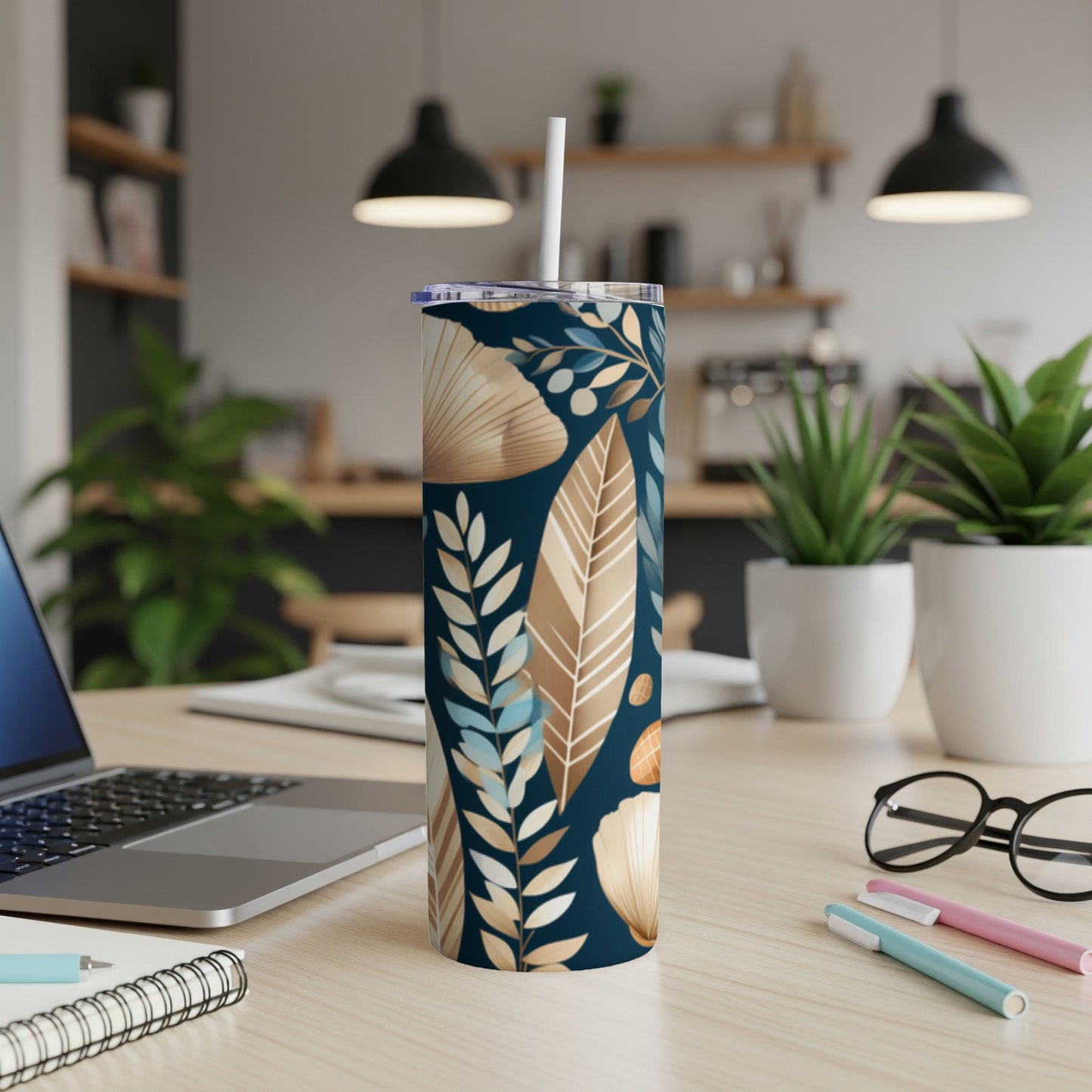 Dark blue tumbler with beige and blue botanical leaf pattern.