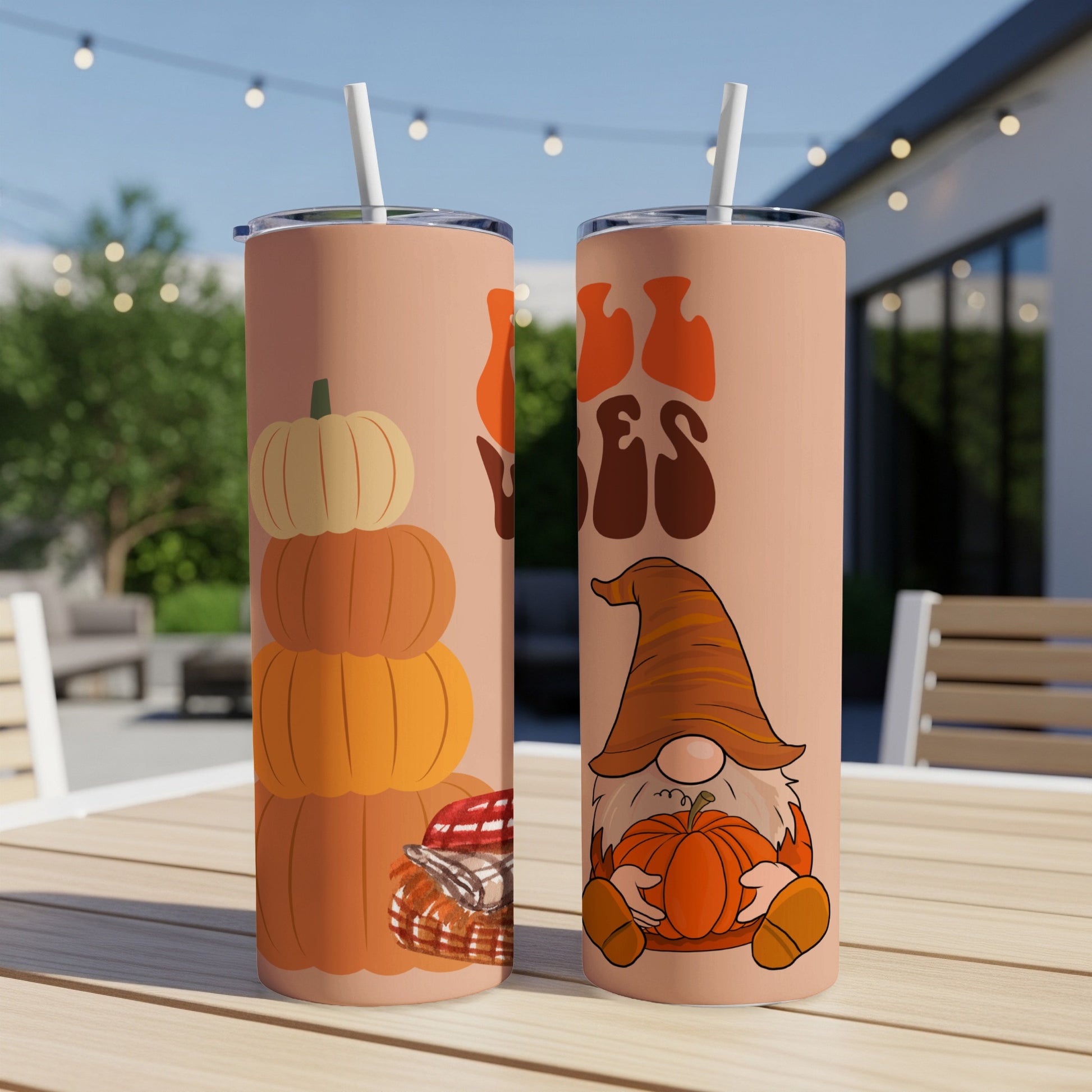 Two fall-themed tumblers, one with pumpkins, one with a gnome.