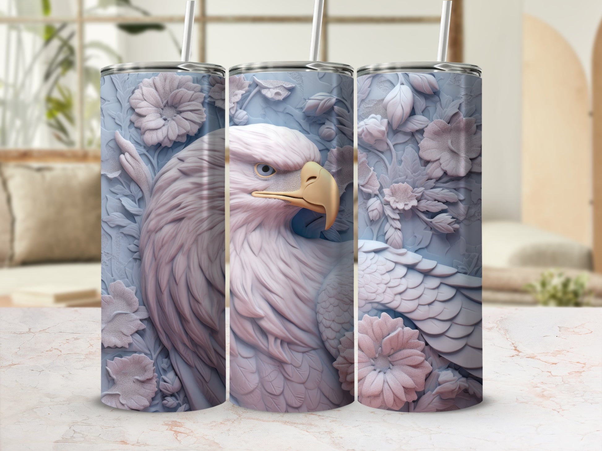 Three light blue tumblers with embossed eagle and floral designs.