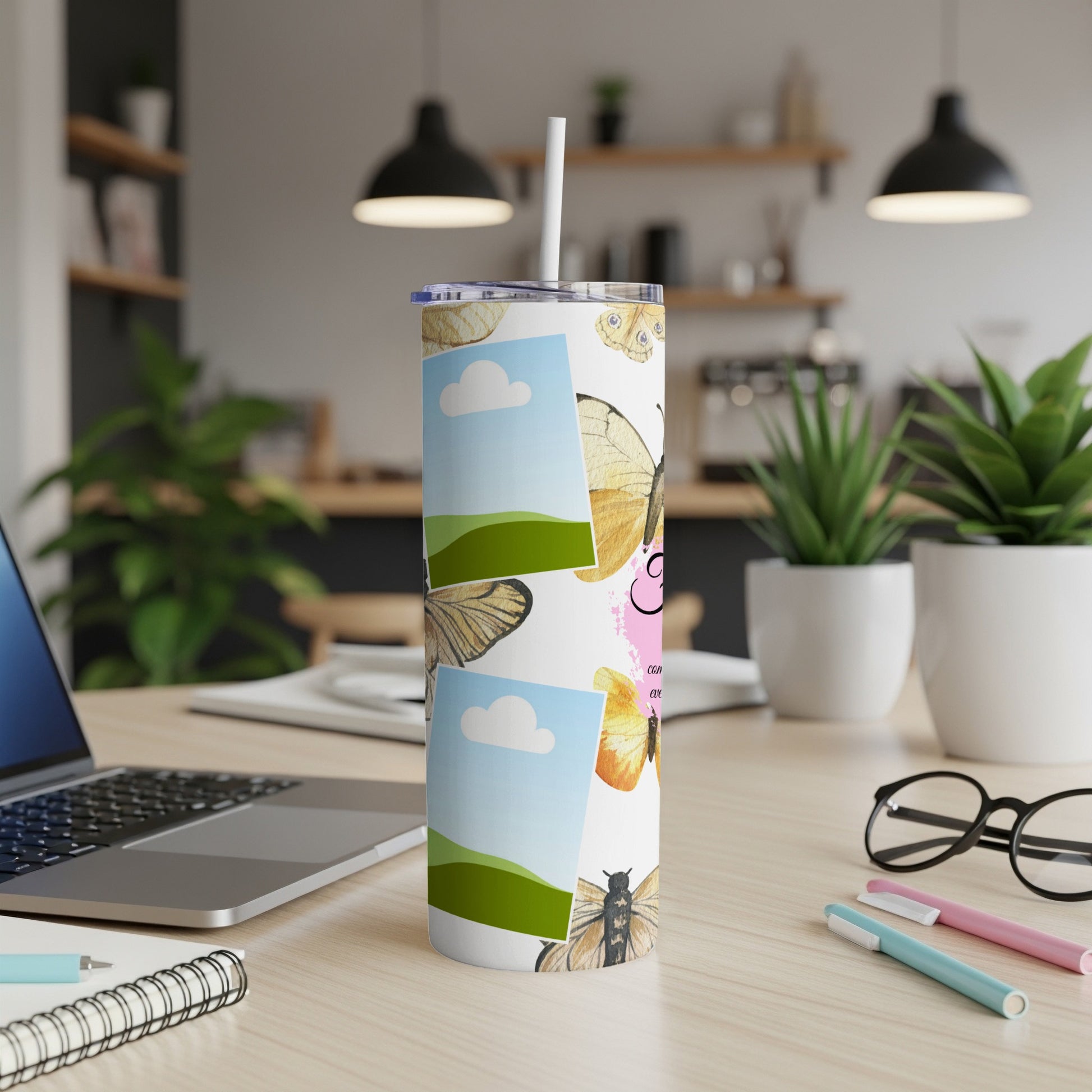 White tumbler with butterflies and blank photo frames, with a straw.