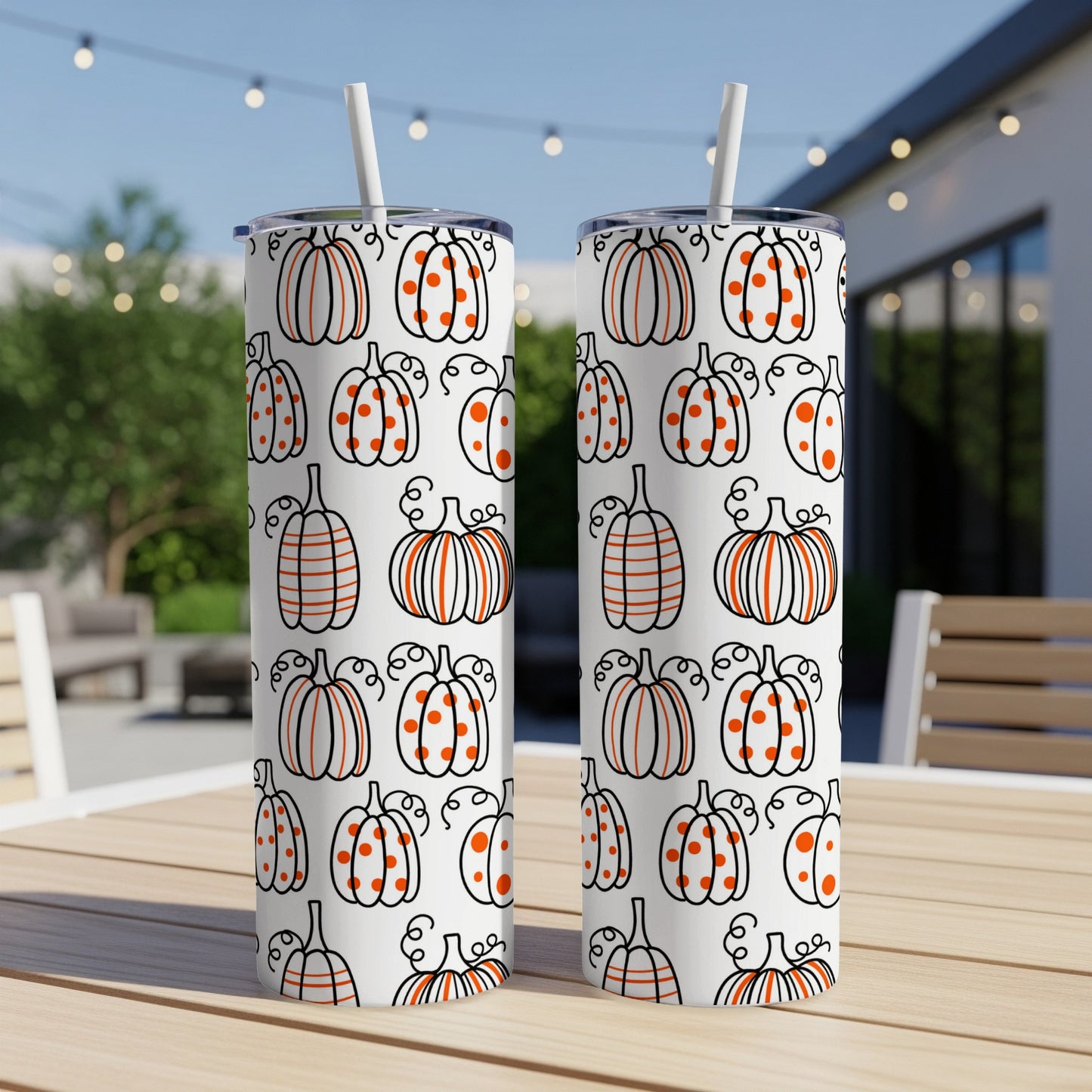 White tumblers with a repeating pattern of orange pumpkins and dots.
