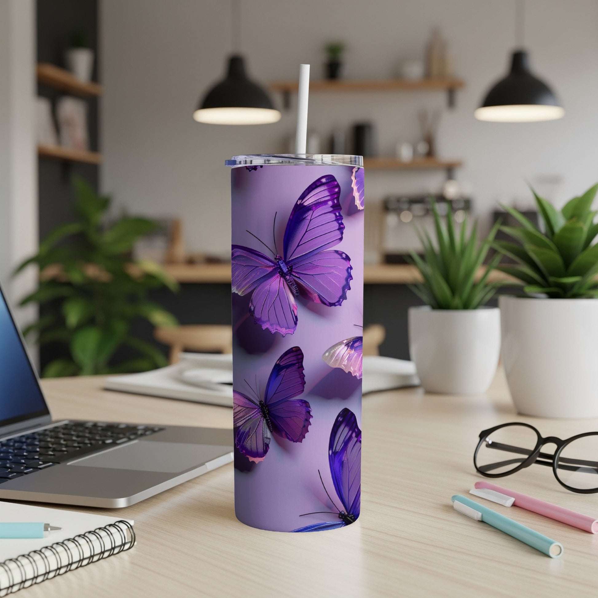 Purple butterflies on a lilac tumbler with a straw, on a desk.