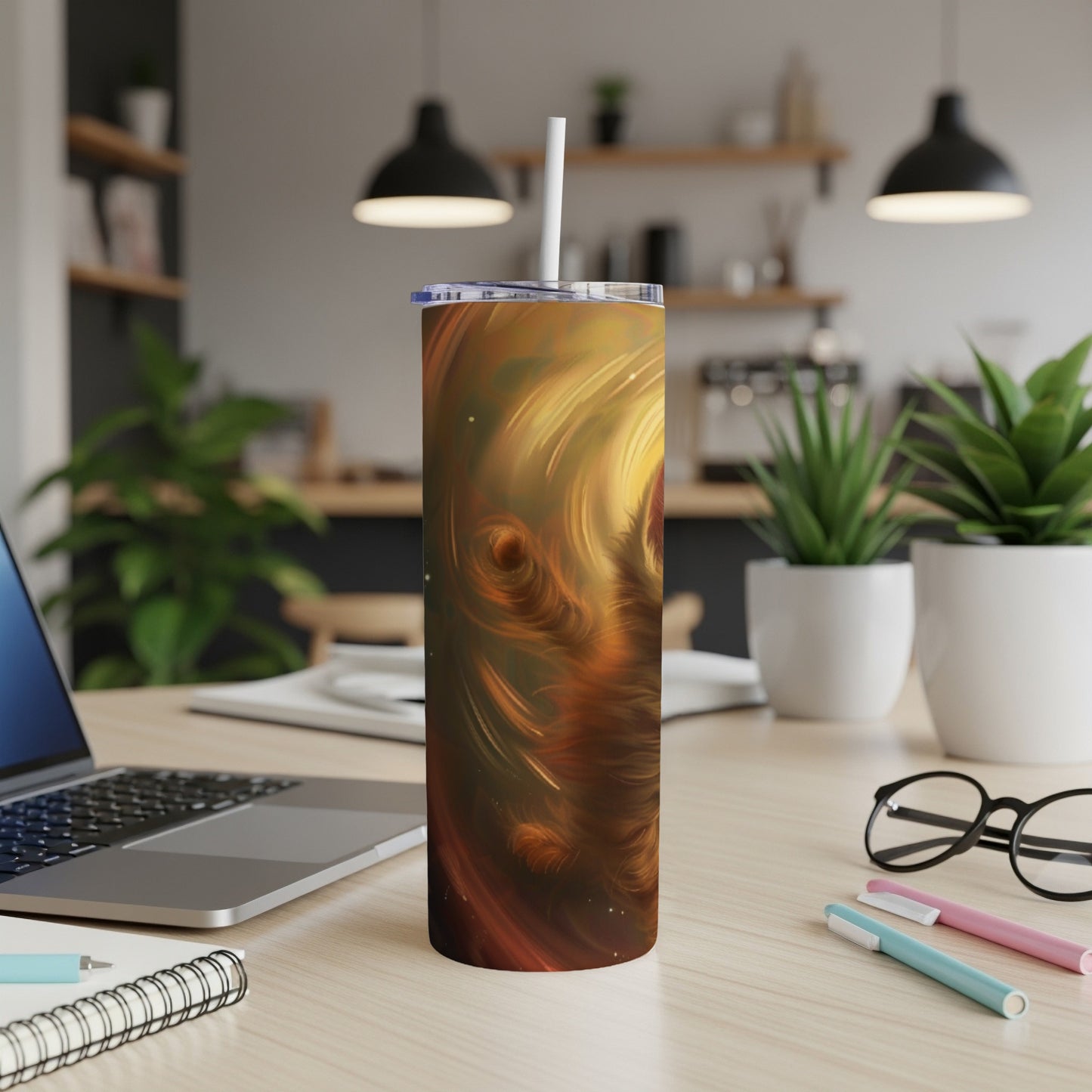 Orange and gold abstract swirl design on a skinny tumbler with straw.