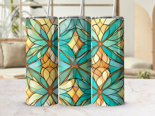 Three stained glass pattern tumblers with straws, on a marble surface.