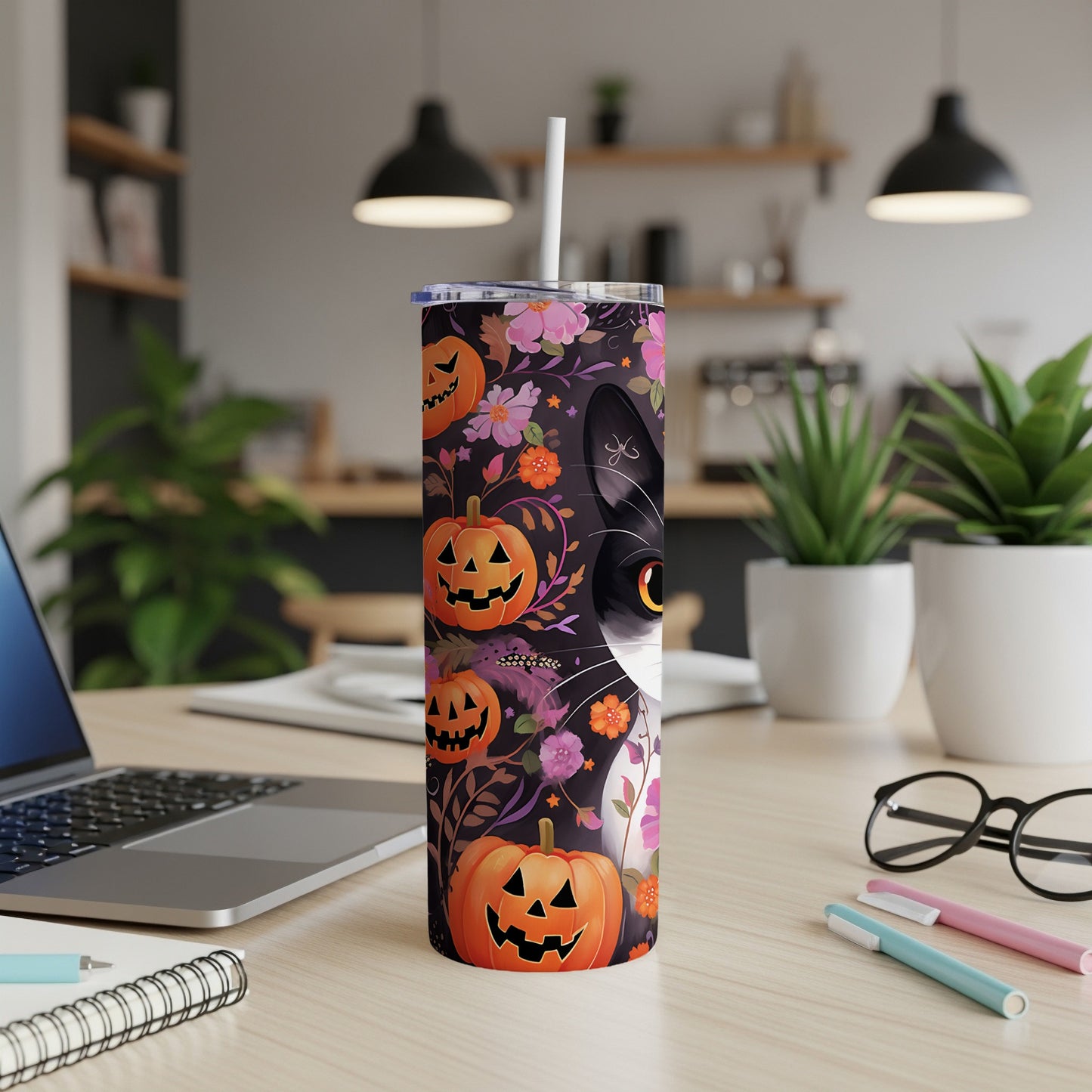 Black and white cat tumbler with pumpkins and floral Halloween pattern.