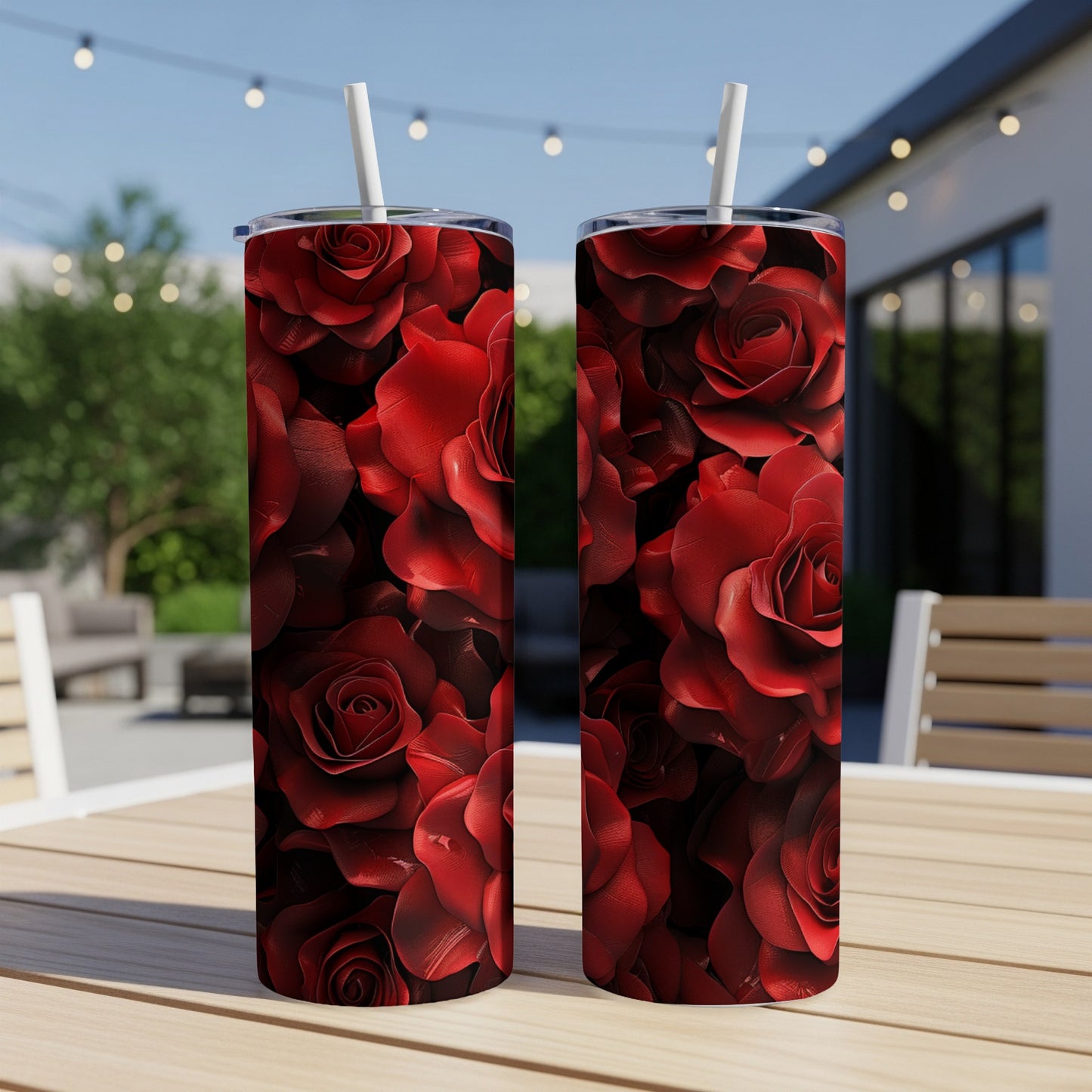Two tall tumblers with a detailed red rose pattern, resting on a table.