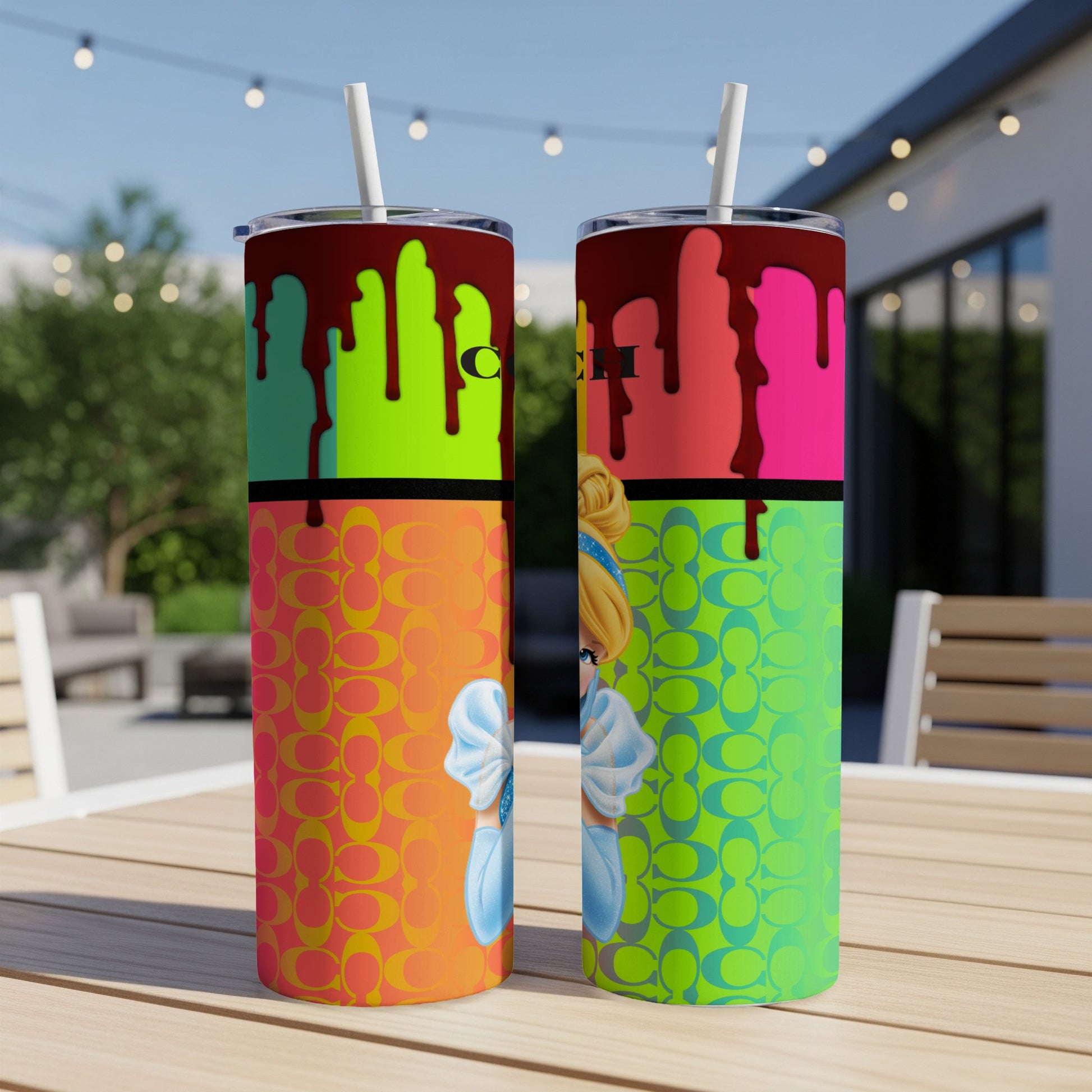 Two tumblers with dripping paint design and Cinderella graphic accents.
