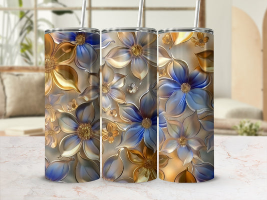Three metallic tumblers with embossed floral designs in gold and blue.