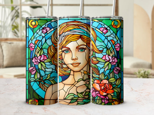 Stained glass tumbler featuring a woman's portrait with flowers and geometric patterns.