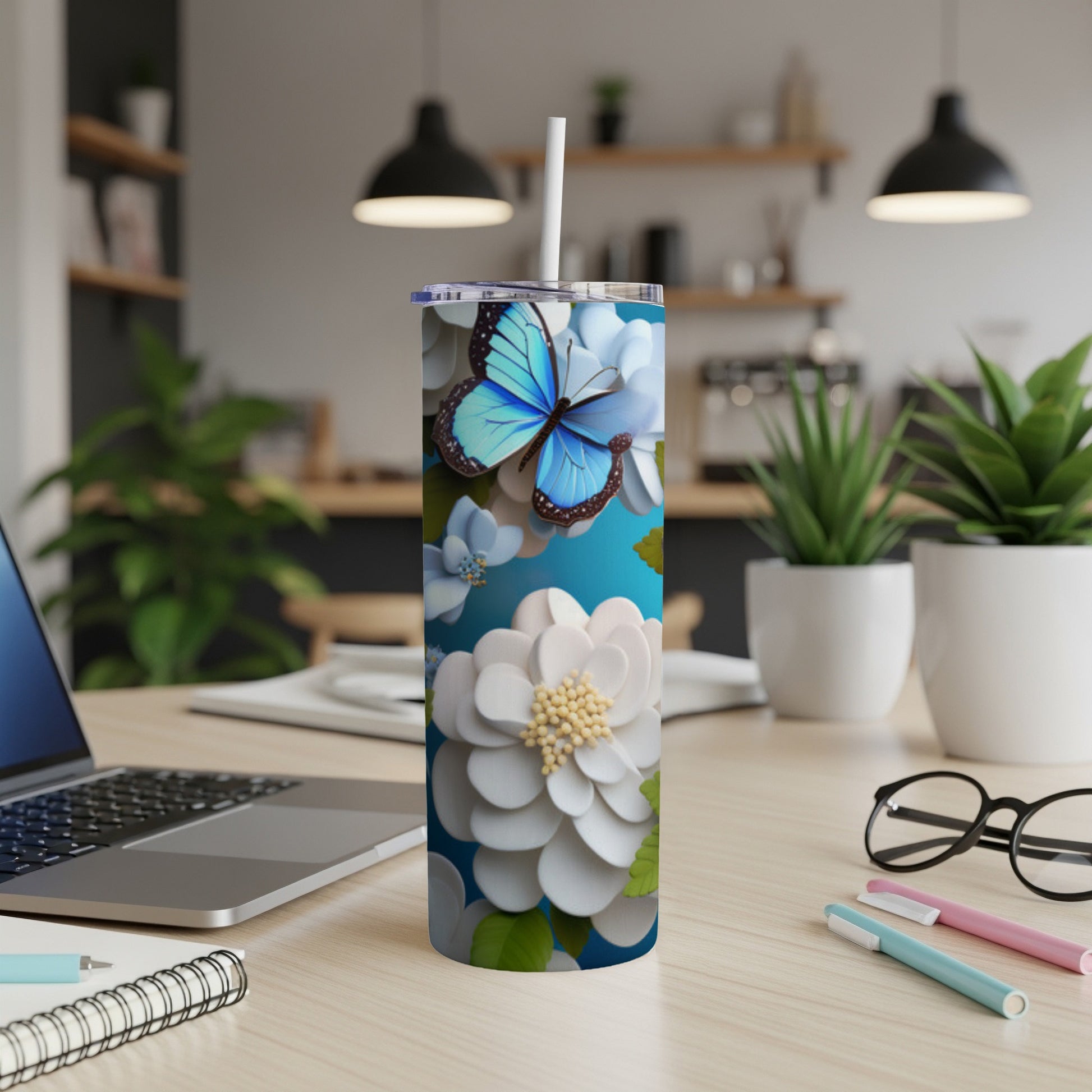 Blue butterfly and white flowers on a light blue tumbler.