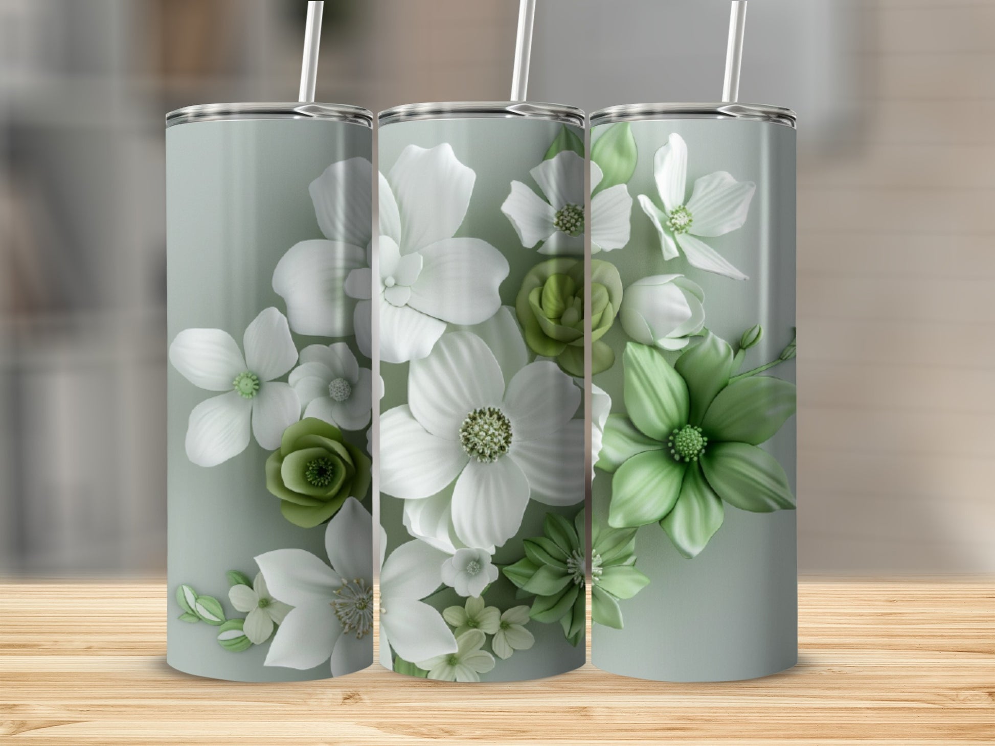 Three floral tumblers with white and green flowers on a light gray background.