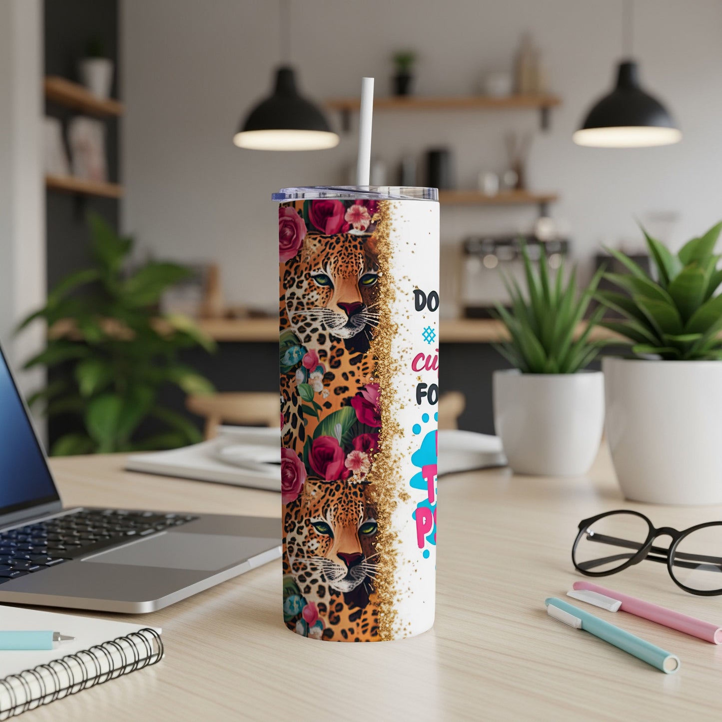 Leopard print tumbler with floral accents and "Do what you love" text.