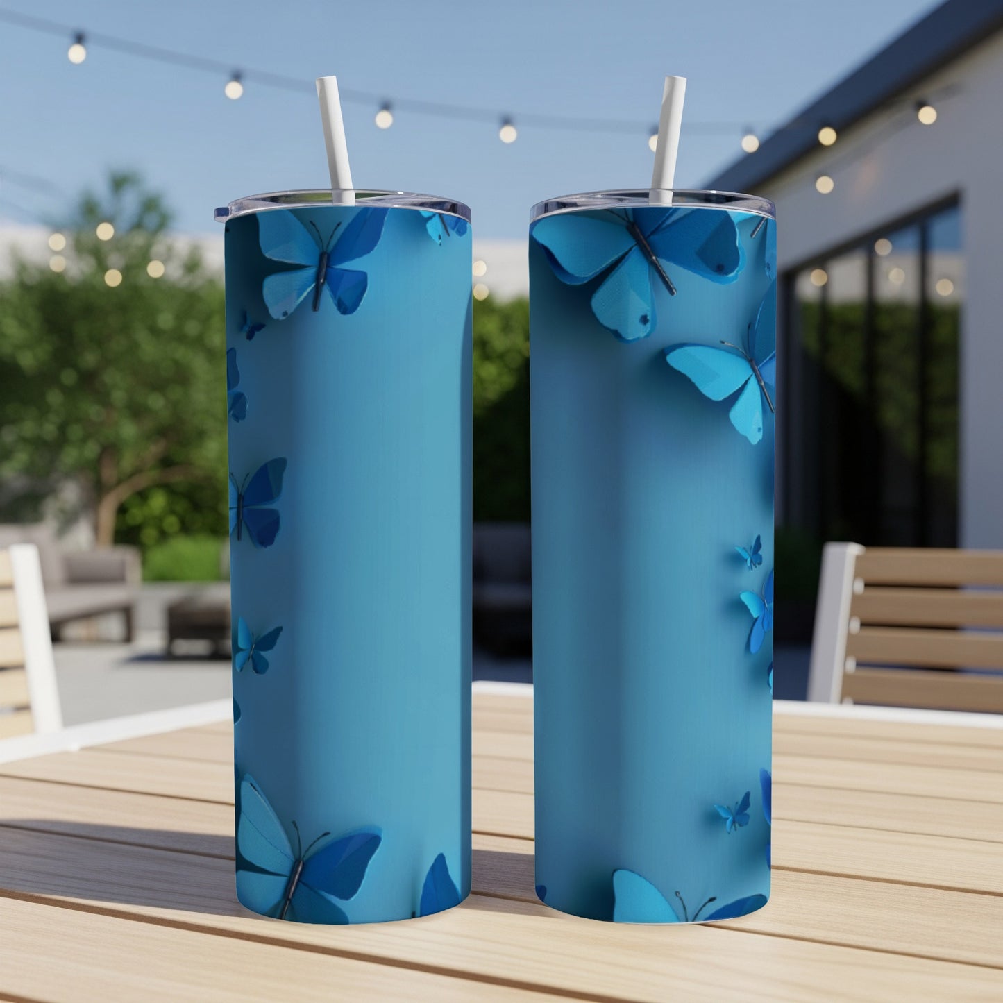 Two blue tumblers with scattered blue butterflies on a teal background.