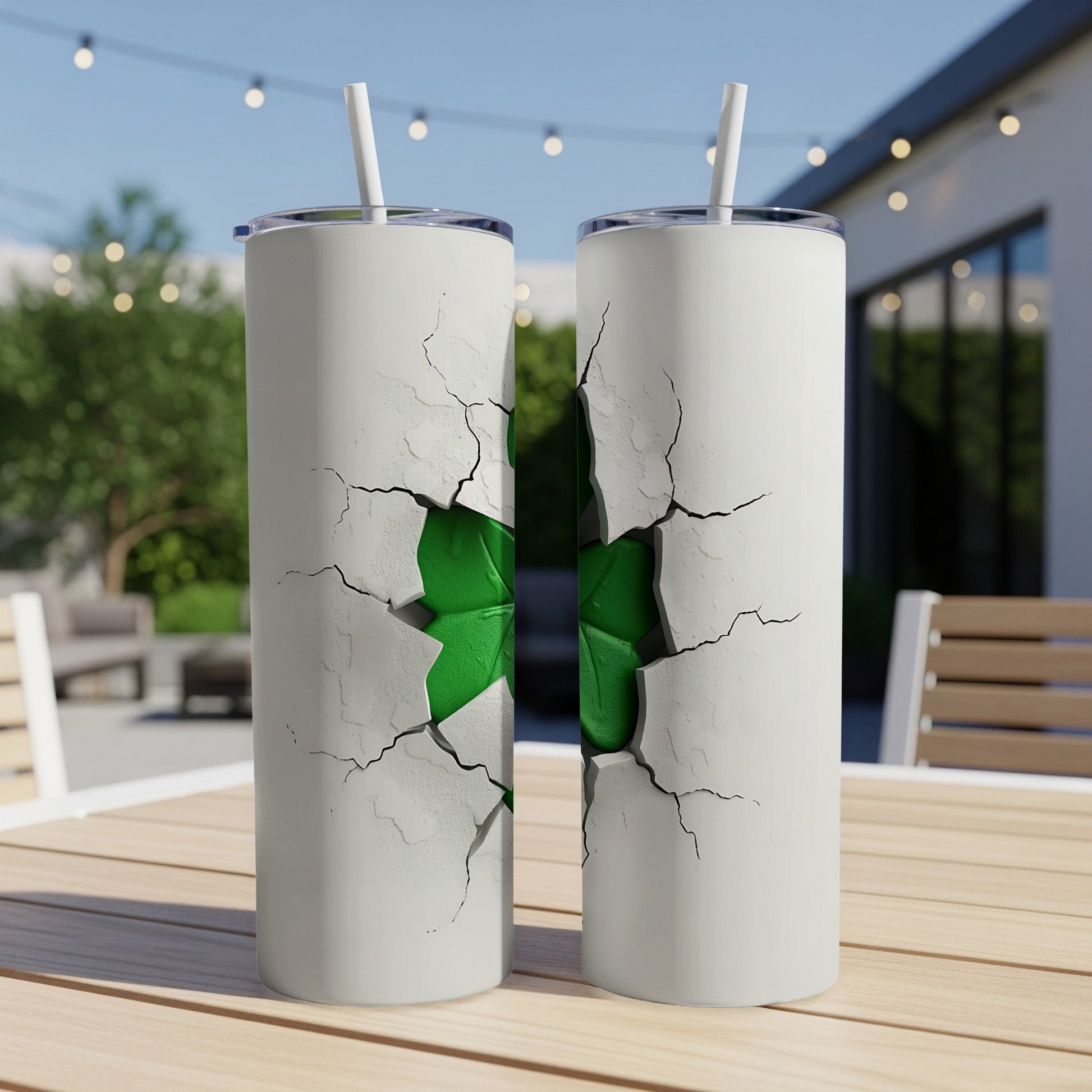 White tumblers with cracked design revealing green shamrock inside, outdoor table setting.