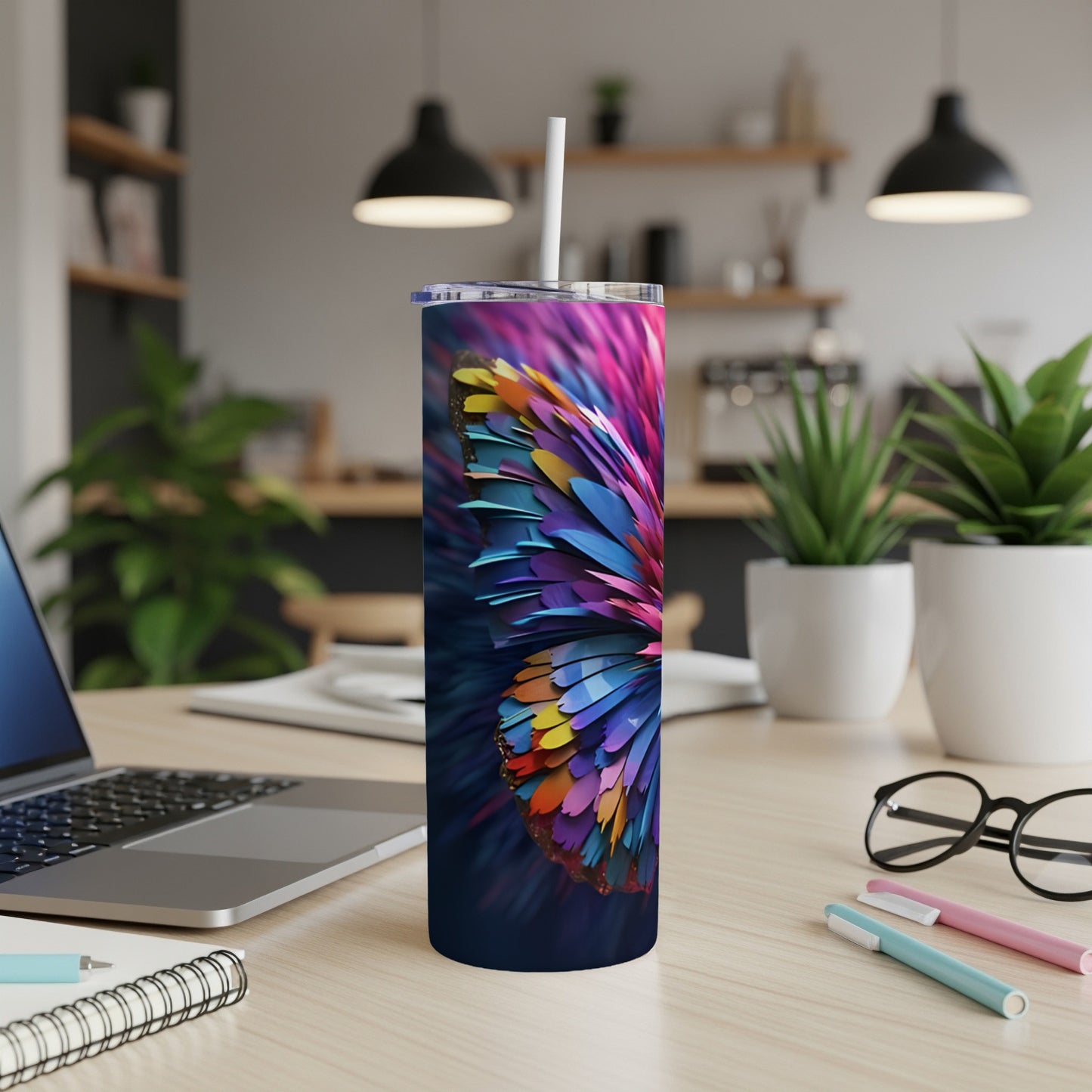 Colorful butterfly wing pattern on a navy blue skinny tumbler with straw.