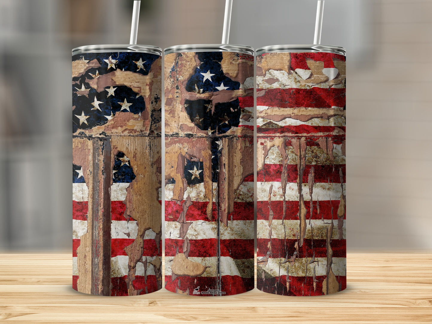Distressed American flag pattern on three stainless steel tumblers with straws.