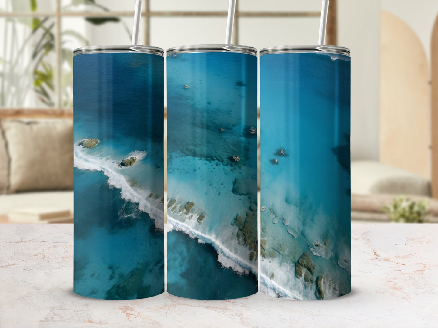 Three tumblers featuring aerial view of tropical ocean coastline with turquoise water.