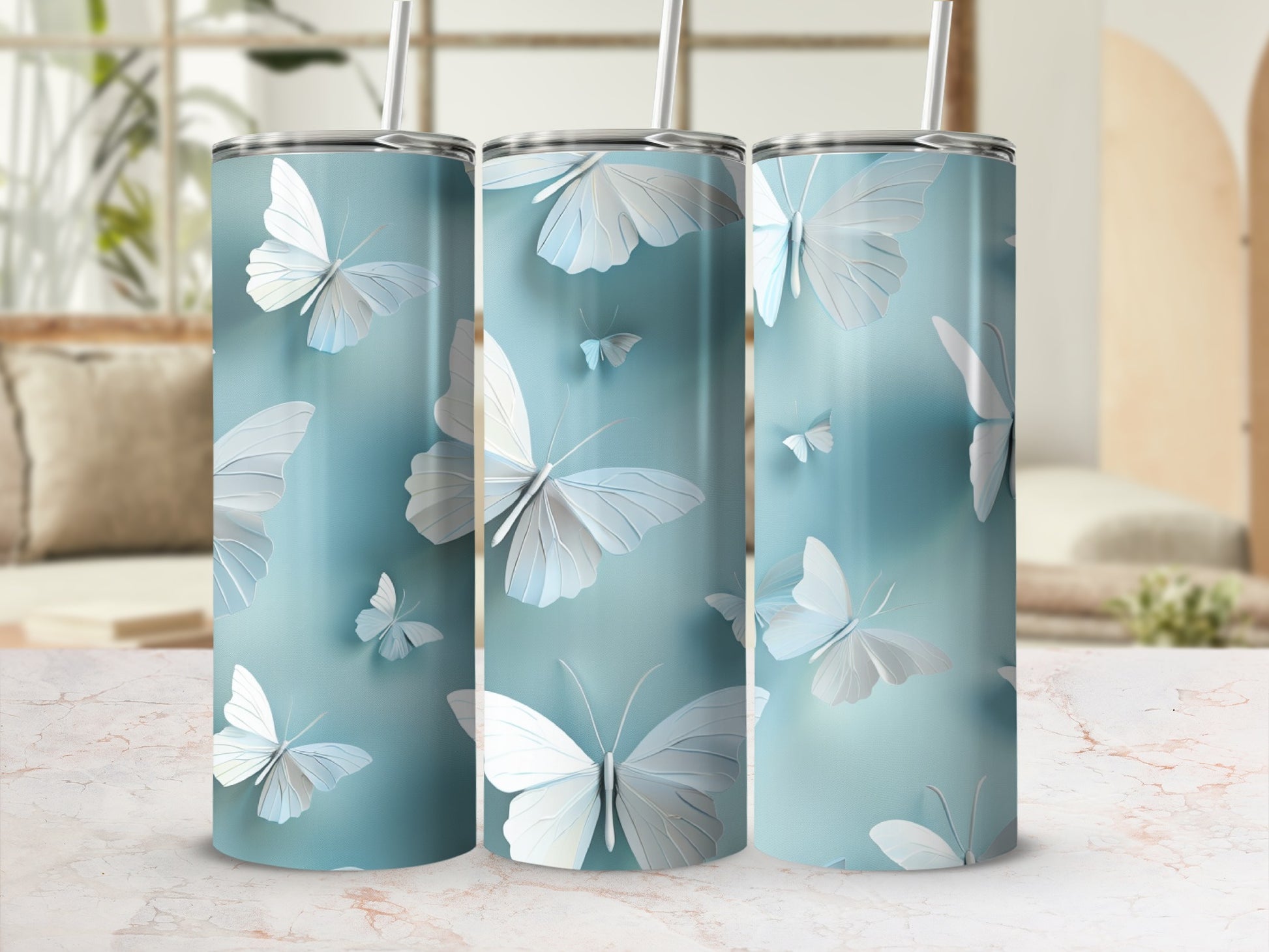Three tall tumblers with a light blue watercolor background and white butterfly designs.
