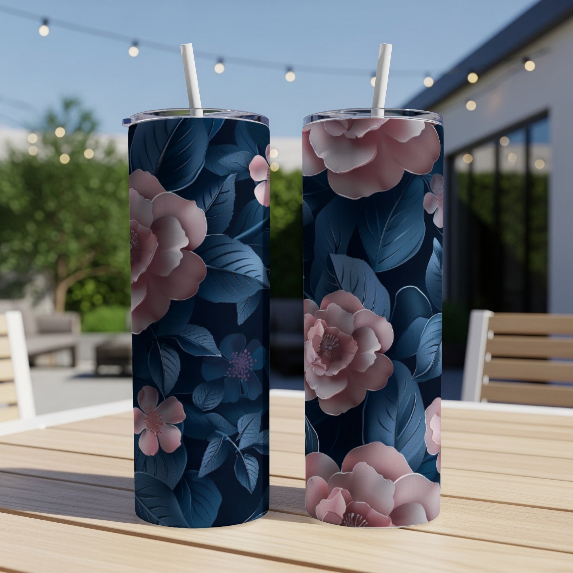 Two tumblers with a pink and blue floral pattern sit on a table.