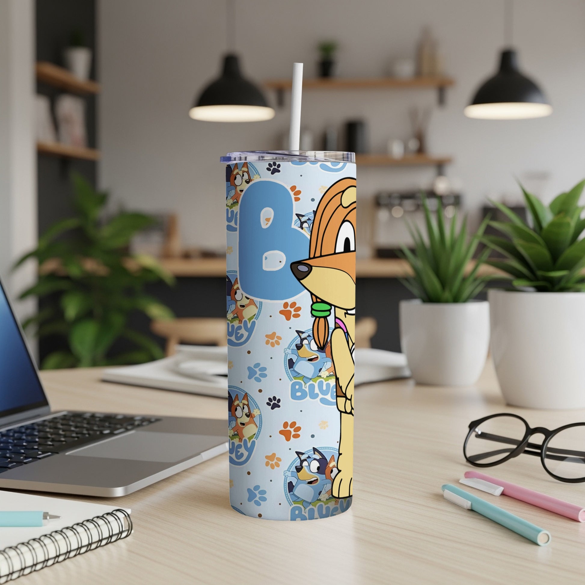 Bluey character tumbler with straw on a desk.