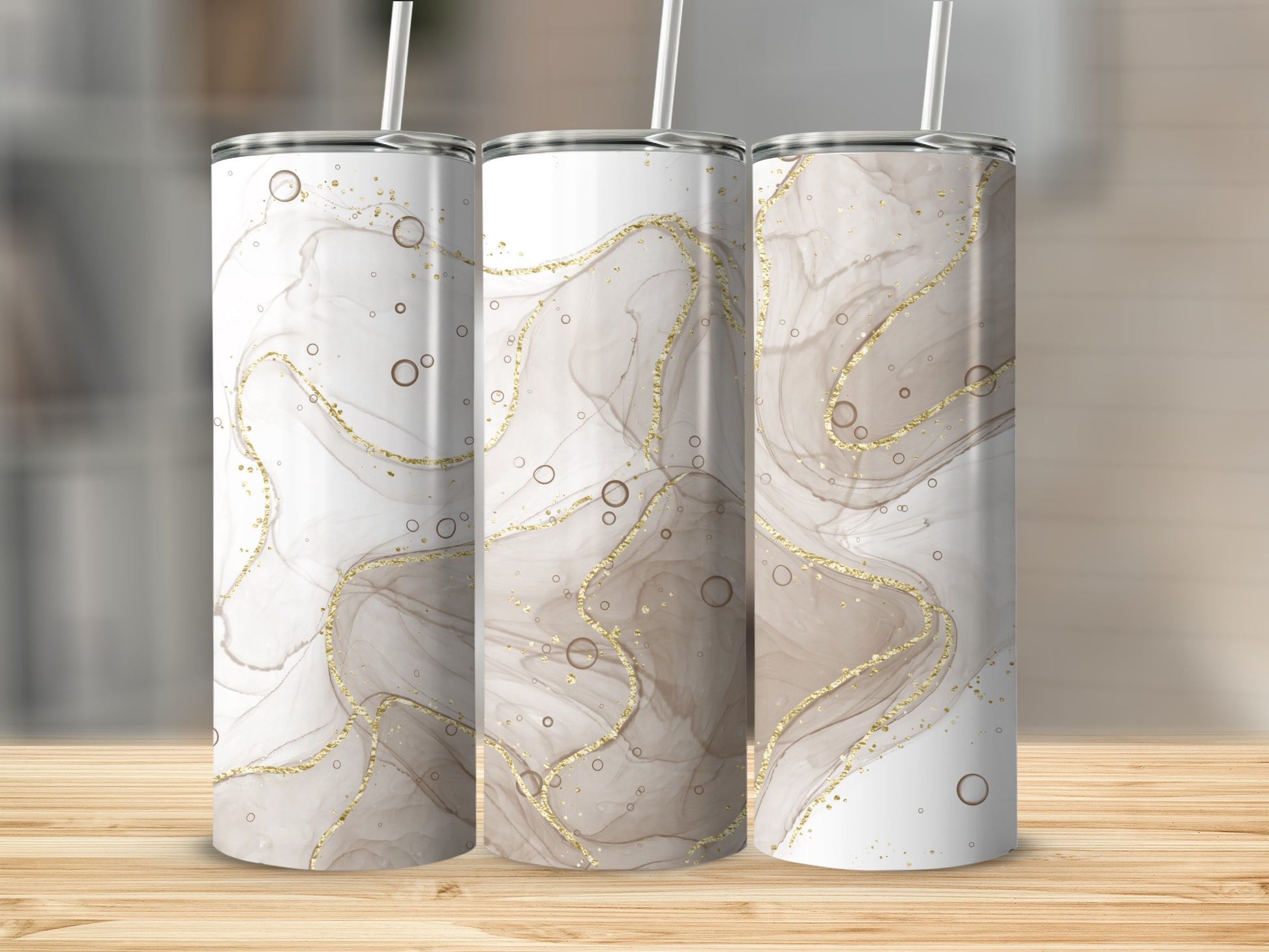 Three tumblers with marbled brown and gold abstract design and straws.