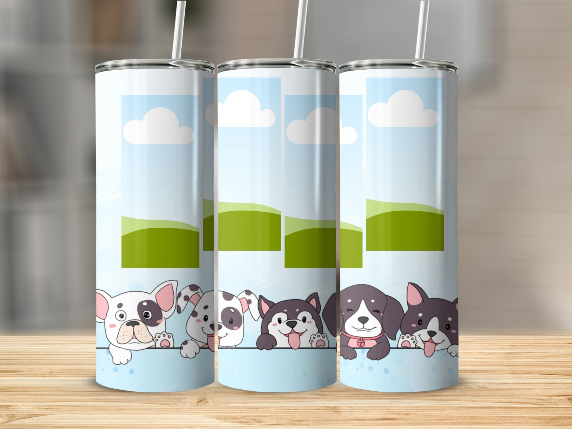Three tumblers with cartoon dogs and a sky and hill design.