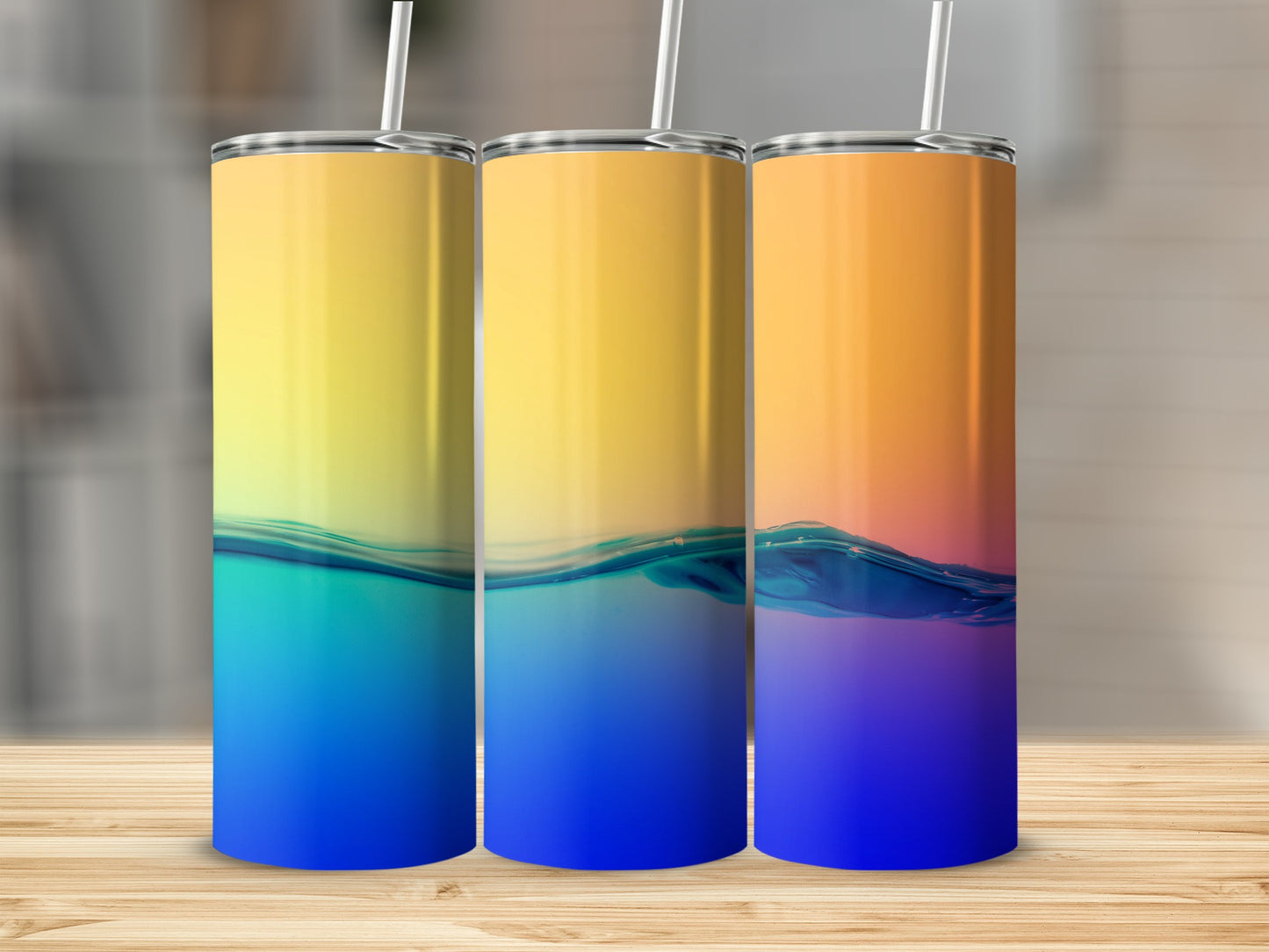 Three tumblers with gradient yellow to blue and orange to purple water designs.